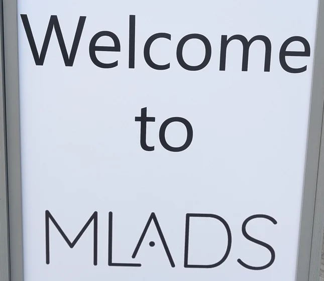 A sign that reads “Welcome to MLADS,” where “Welcome to” is set in Segoe UI, and “MLADS” is custom logotype.