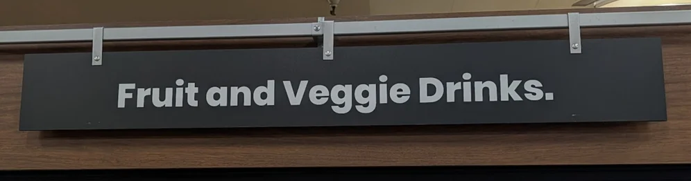 A panel that reads “Fruit and Veggie Drinks.” set in a bold geometric sans serif. The tittle in “i” is round, while period at the end is rectangular.